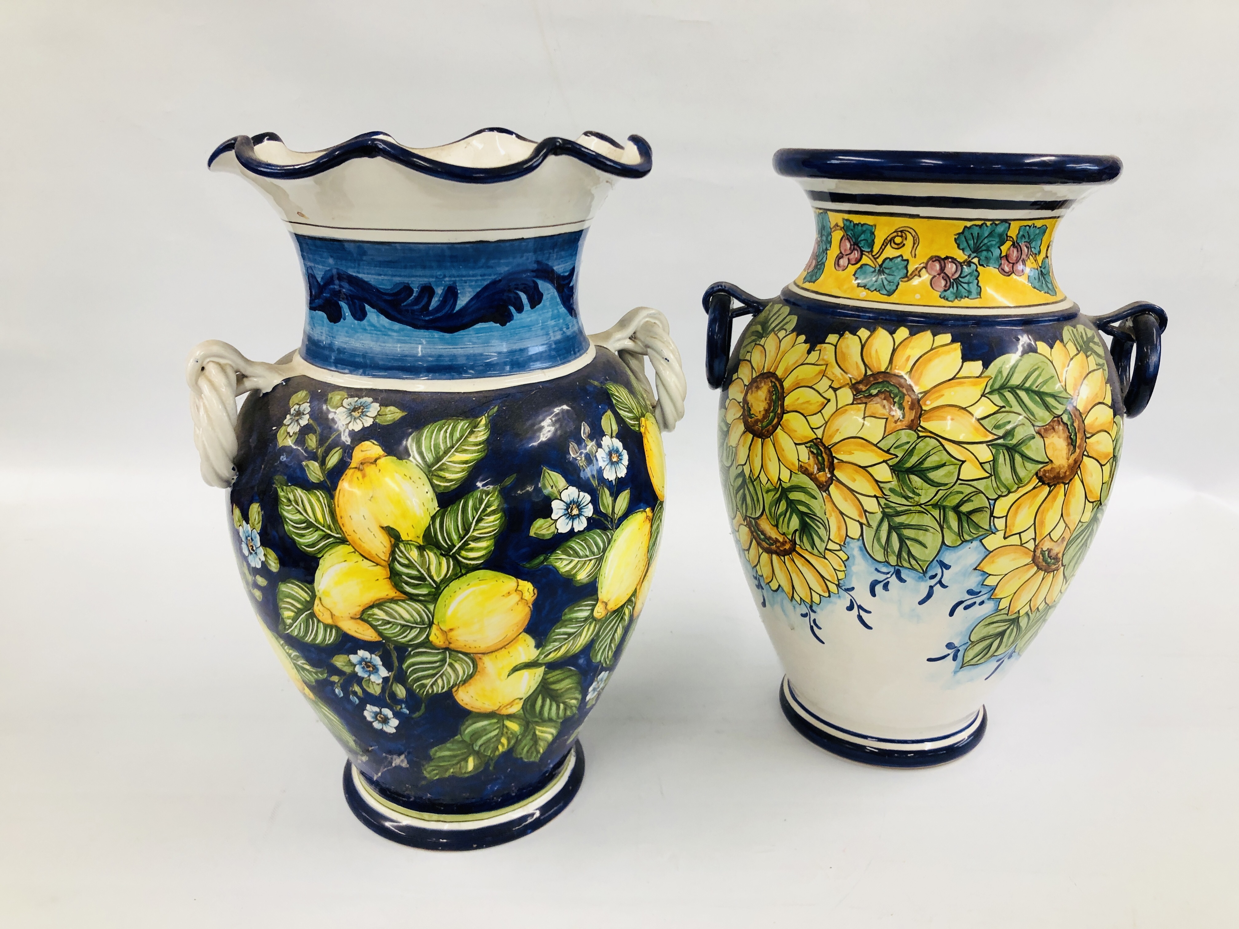 TWO LARGE CONTINENTAL GLAZED VASES ONE DECORATED WITH SUNFLOWERS, H 55.5CM THE OTHER LEMONS, H 56CM.
