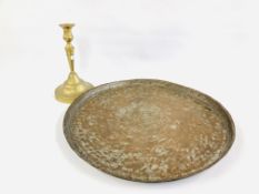 A LARGE MIDDLE EASTERN BRASS CANDLESTICK ON A CIRCULAR BASE H 39.