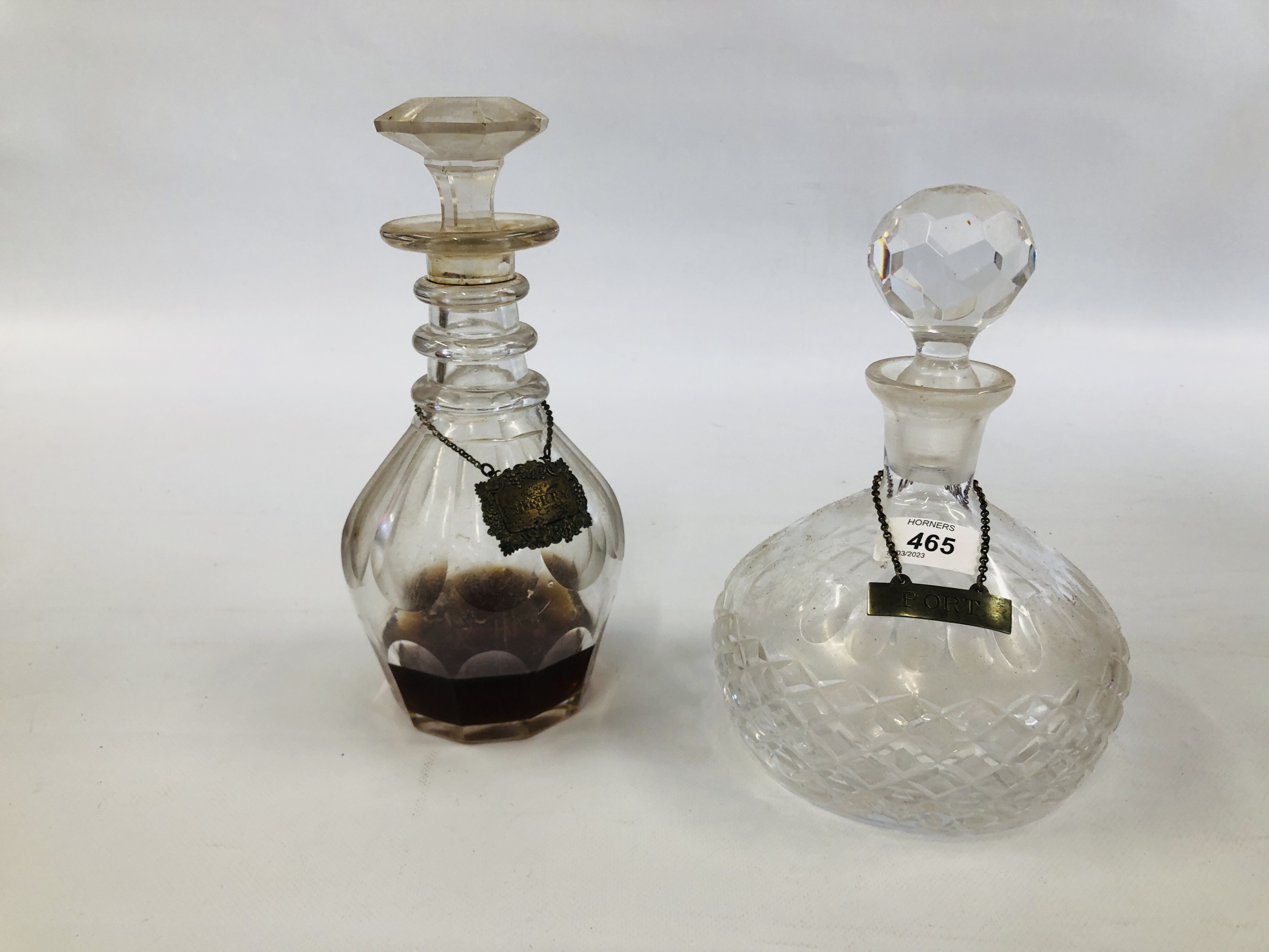 TWO VINTAGE GLASS DECANTERS ALONG WITH TWO SILVER DECANTER LABELS PORT AND SHERRY.