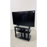 SONY 43" FLAT SCREEN TV MODEL KD-43XE8005 ON MODERN BLACK FINISH GLASS STAND WITH REMOTE - SOLD AS