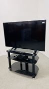 SONY 43" FLAT SCREEN TV MODEL KD-43XE8005 ON MODERN BLACK FINISH GLASS STAND WITH REMOTE - SOLD AS