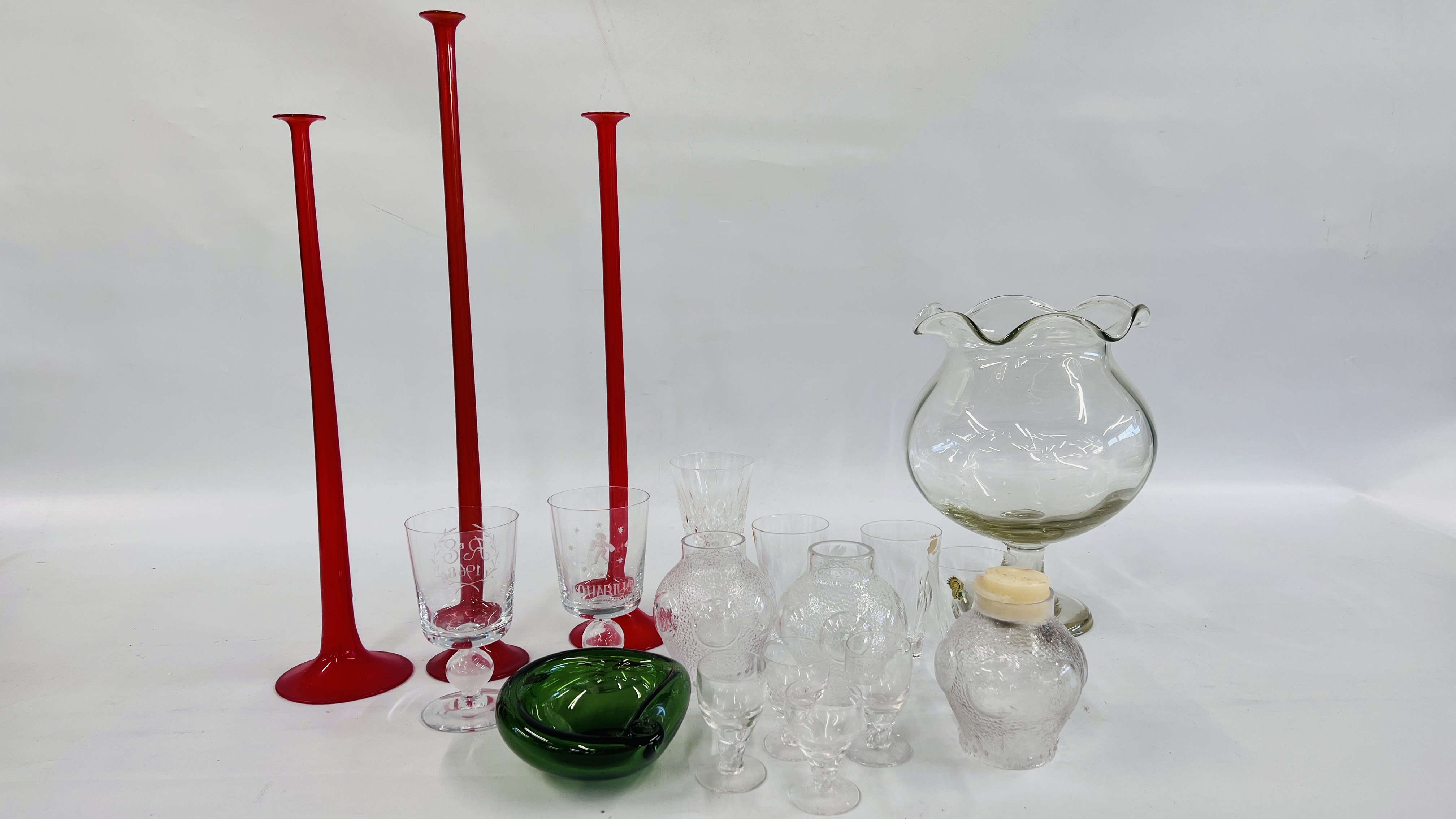 THREE RUBY GLASS LONG STEMMED HOLLOW CANDLESTICKS, THE LARGEST 60CM,