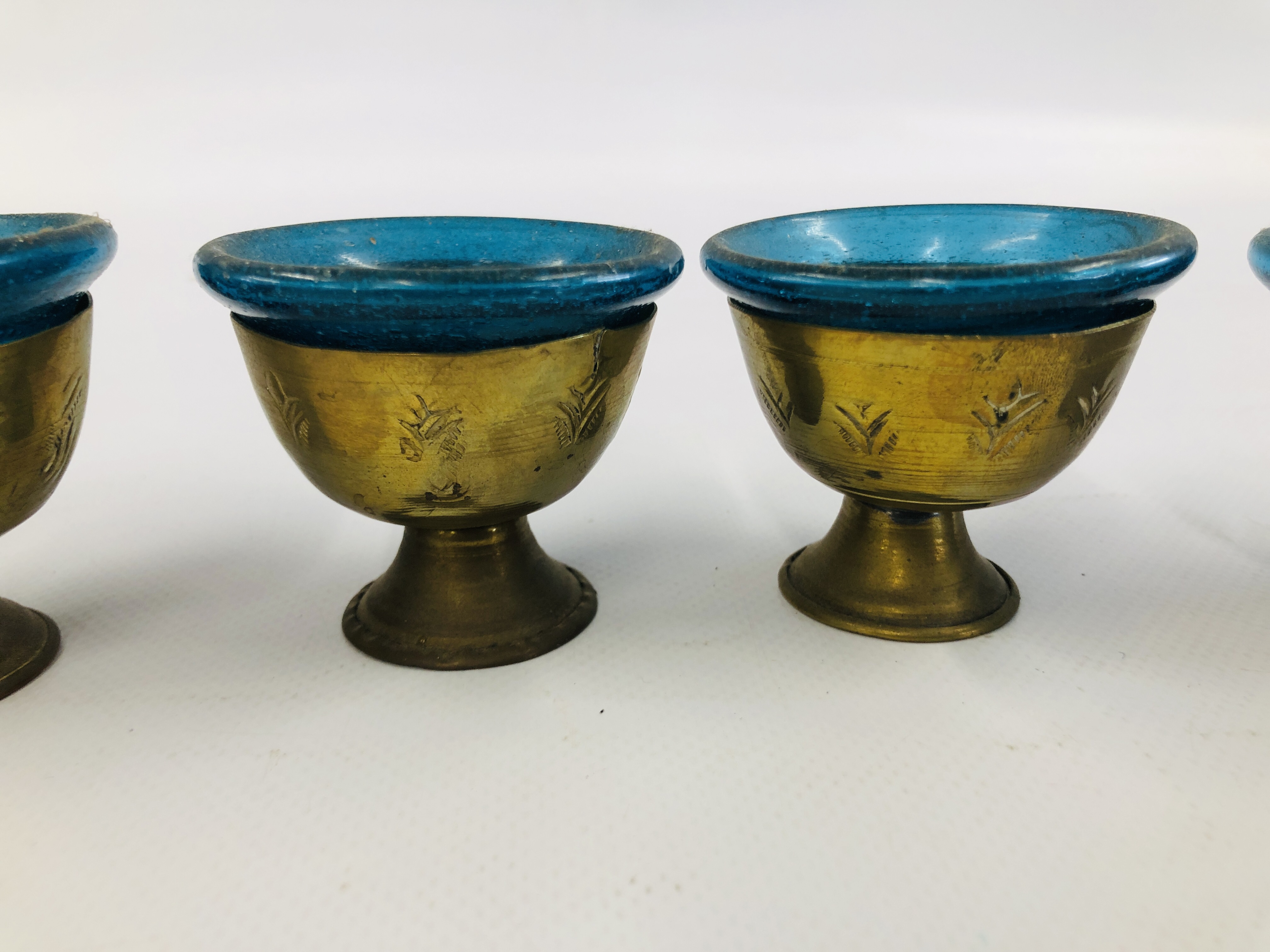 A SET OF SIX MIDDLE EASTERN BRASS GOBLET VESSELS WITH BLUE GLASS LINERS. - Image 3 of 11