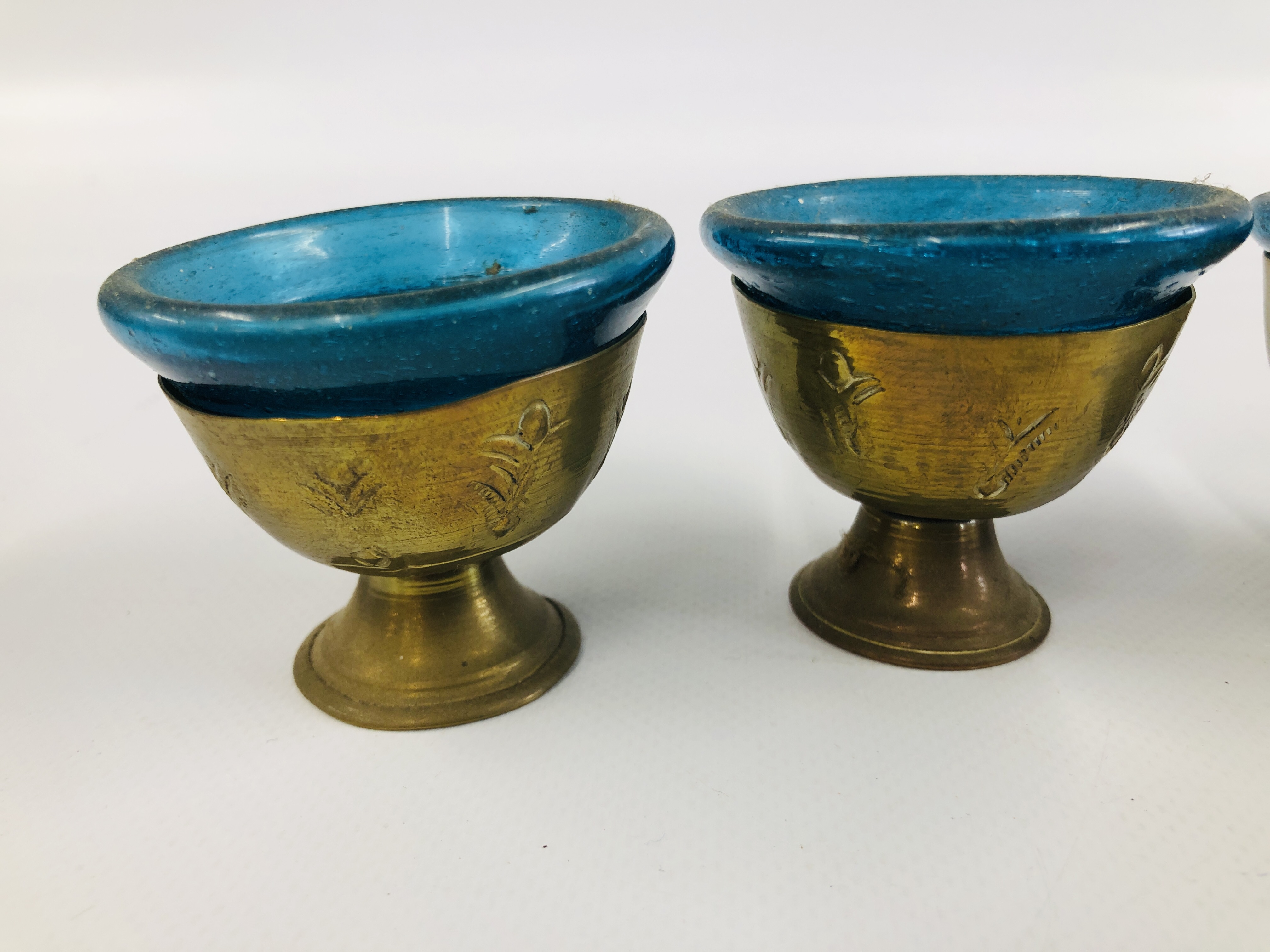 A SET OF SIX MIDDLE EASTERN BRASS GOBLET VESSELS WITH BLUE GLASS LINERS. - Image 2 of 11