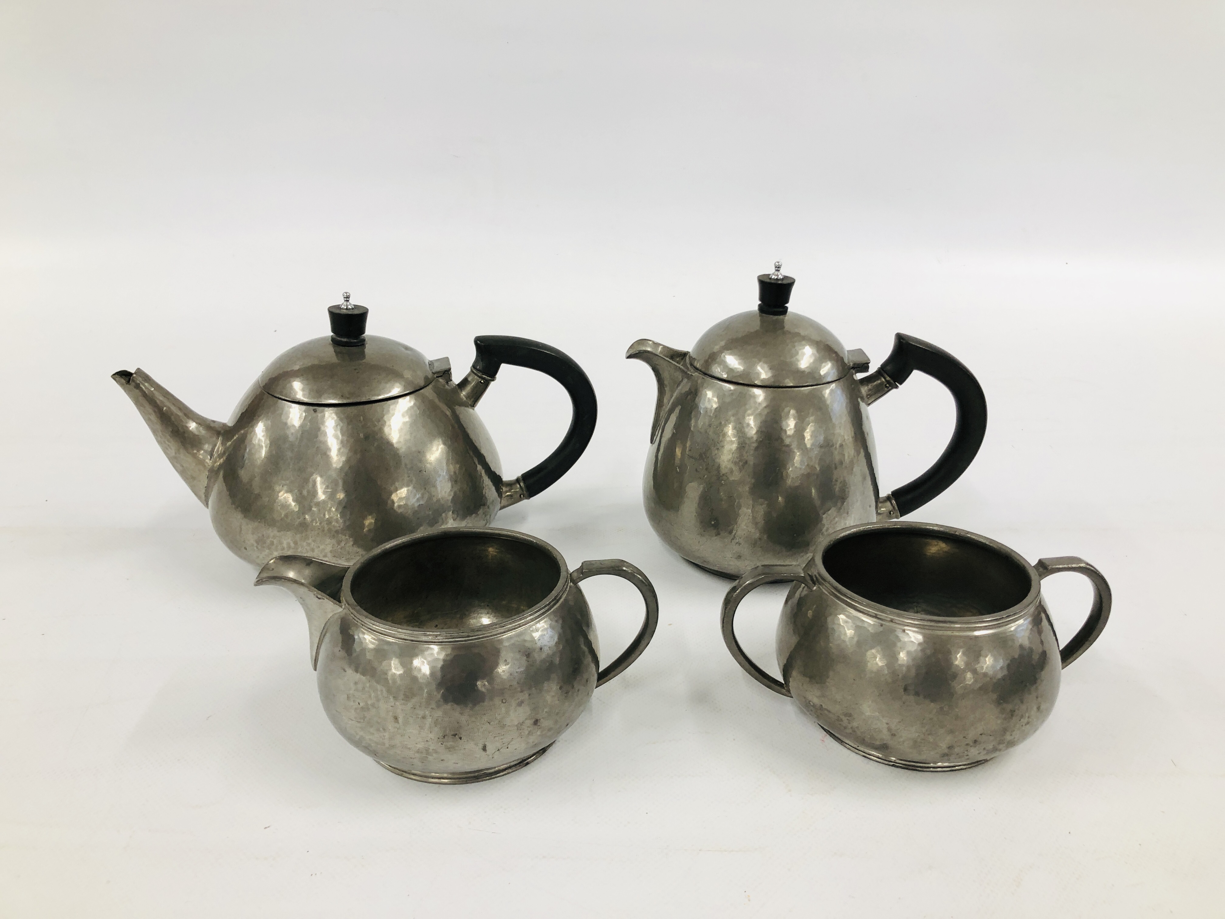 A FOUR PIECE ENGLISH PEWTER TEASET STAMPED LIBERTY & CO.