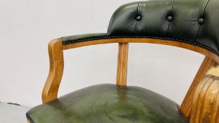 A VINTAGE PINE FRAMED GREEN LEATHER AND BUTTON BACK ARM CHAIR