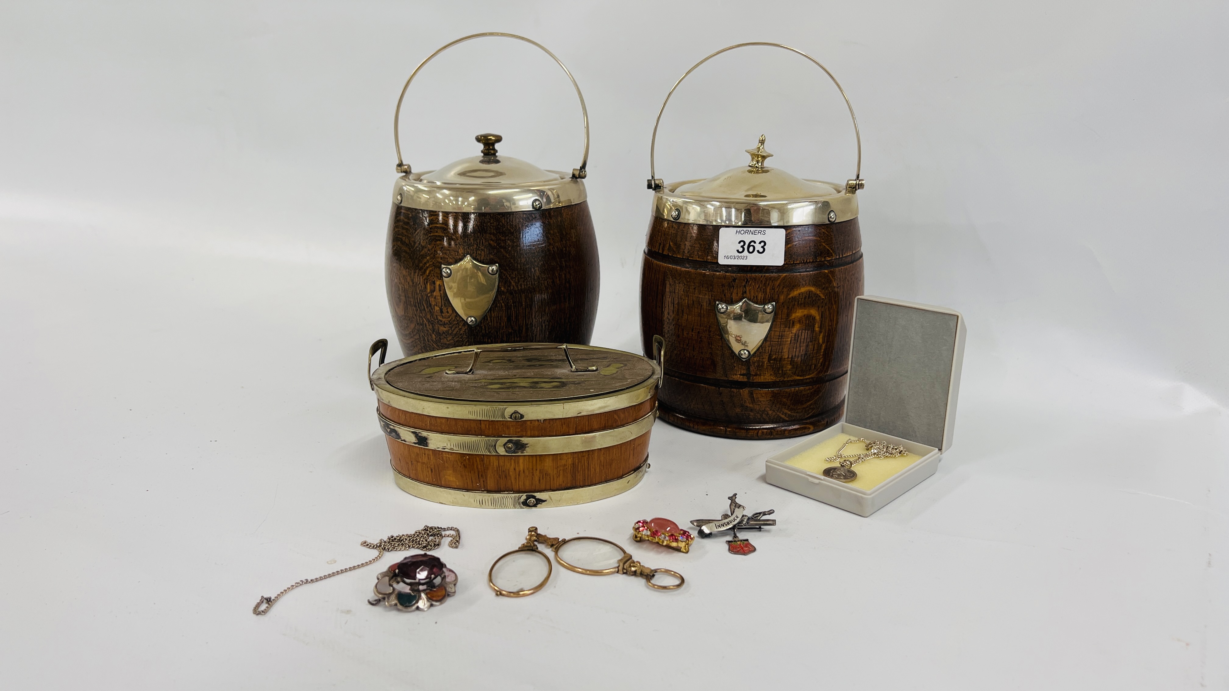 TWO OAK MINIATURE BARRELS WITH SILVER PLATED LIDS AND ONE FURTHER OAK AND PLATED BARREL ALONG WITH