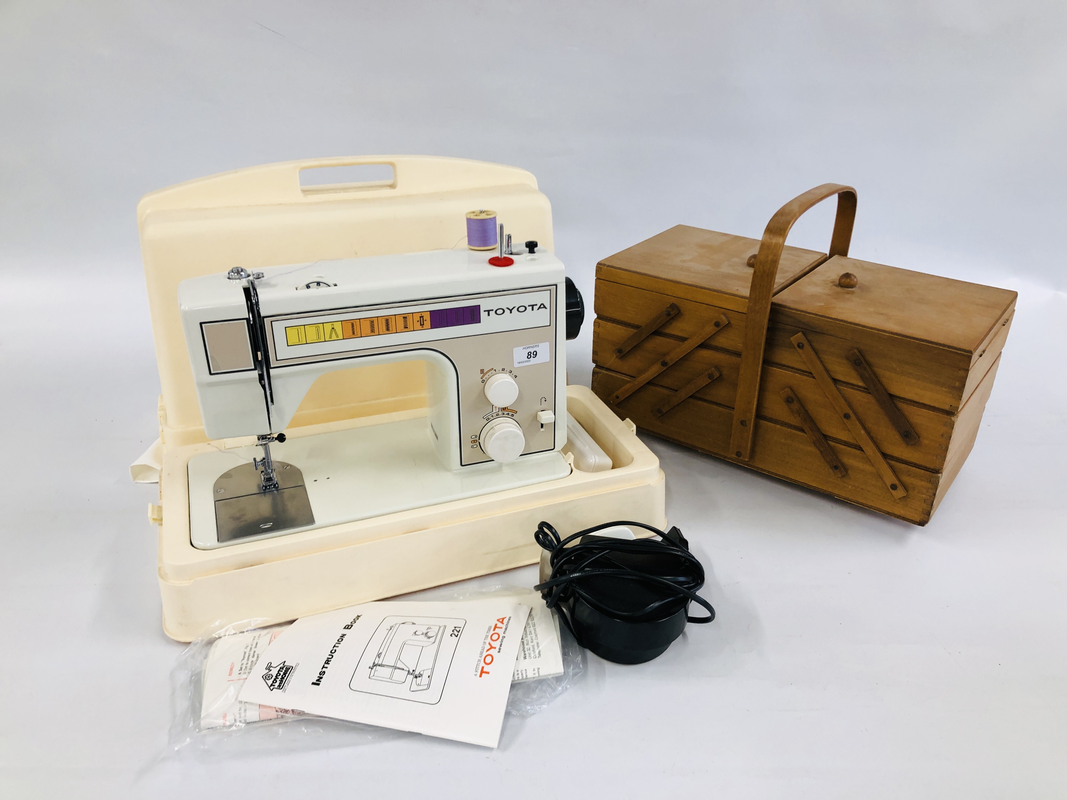 A TOYOTA 221 ELECTRIC SEWING MACHINE IN CASE WITH FOOT PEDAL AND CANTILEVER SEWING BOX WITH