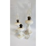 A GROUP OF THREE VINTAGE GRADUATED WHITE GLASS OIL LAMPS