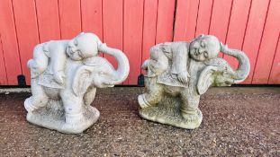 A PAIR OF GARDEN STONEWORK ELEPHANTS CARRYING A CHILD