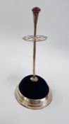 AN ANTIQUE SCOTTISH INSPIRED SILVER HAT PIN STAND, THE FINIAL SET WITH AN AMETHYST COLOURED STONE,