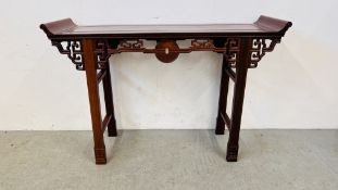 AN ORIENTAL HARDWOOD ALTER TABLE WITH CARVED DETAIL.