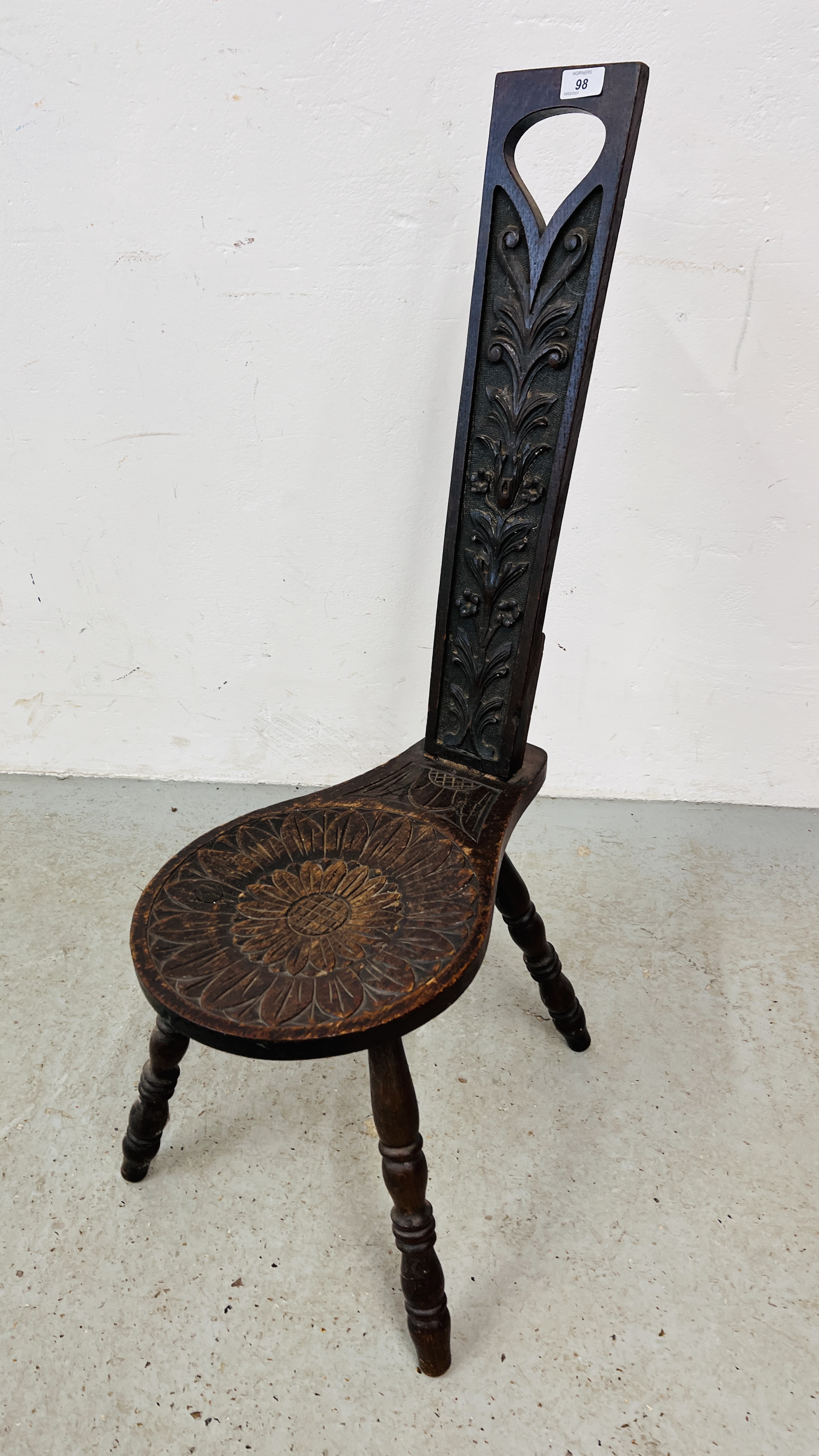 A VINTAGE CARVED OAK SPINNING CHAIR