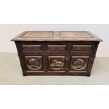 A SOLID OAK ANTIQUE CHEST WITH HAND CARVED PORTRAIT PANELS THE CENTRAL PANEL DEPICTING A SPHINX