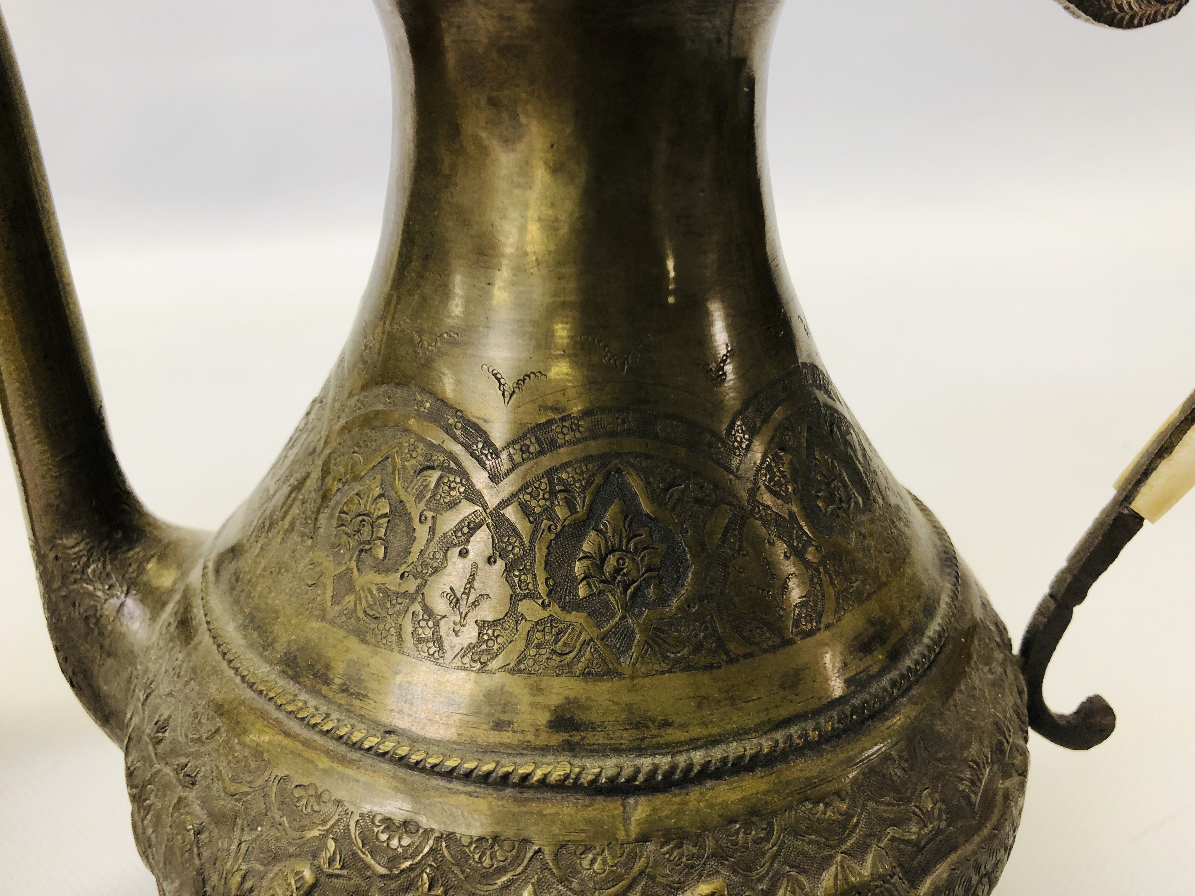 A VINTAGE MIDDLE EASTERN BRASS EWER ALONG WITH AN ELABORATE MIDDLE EASTERN BRASS COFFEE POT. - Image 3 of 21