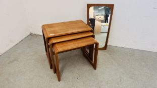 A NEST OF THREE TEAK DANISH DESIGN OCCASIONAL TABLES ALONG WITH DANISH TEAK FRAMED WALL MIRROR.