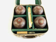 A SET OF FOUR HENSELITE SUPER GRIP LAWN BOWLS IN FITTED LEATHER TRAVEL CASE