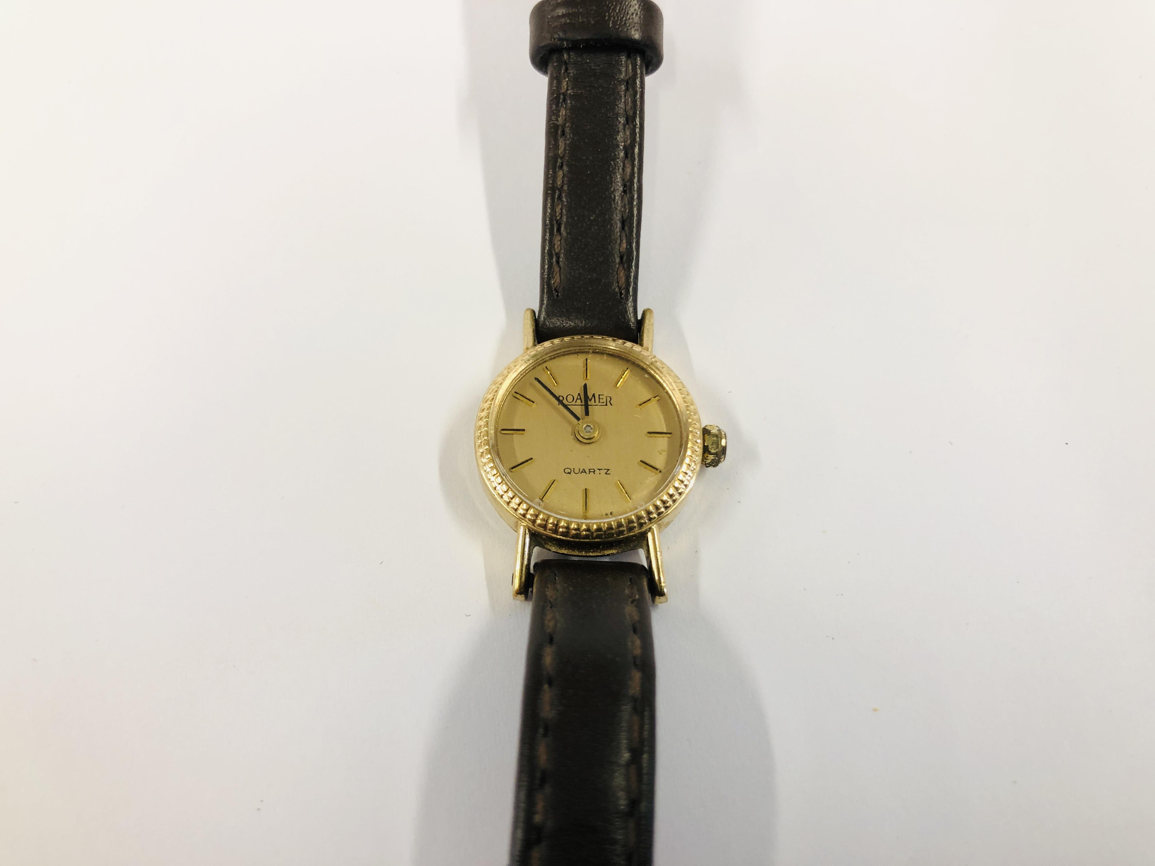 LADIES ROAMER 9CT GOLD CASED WRIST WATCH ON A BROWN LEATHER STRAP.