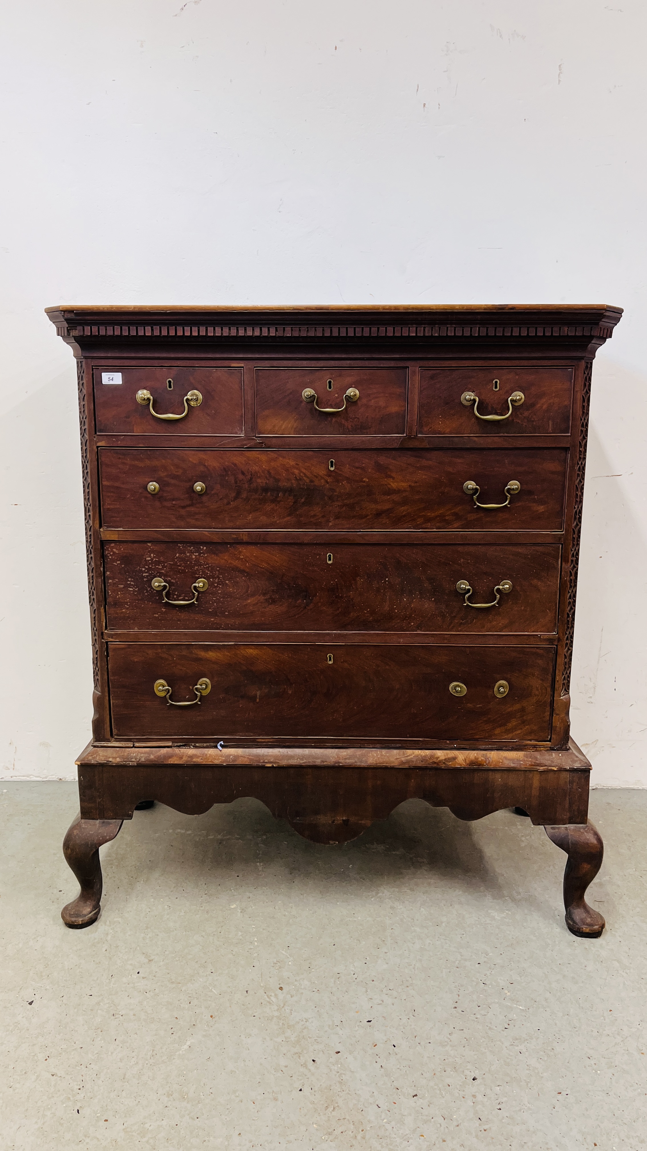 AN ANTIQUE MAHOGANY THREE OVER THREE DRAWER CHEST ON SPLAYED LEG,