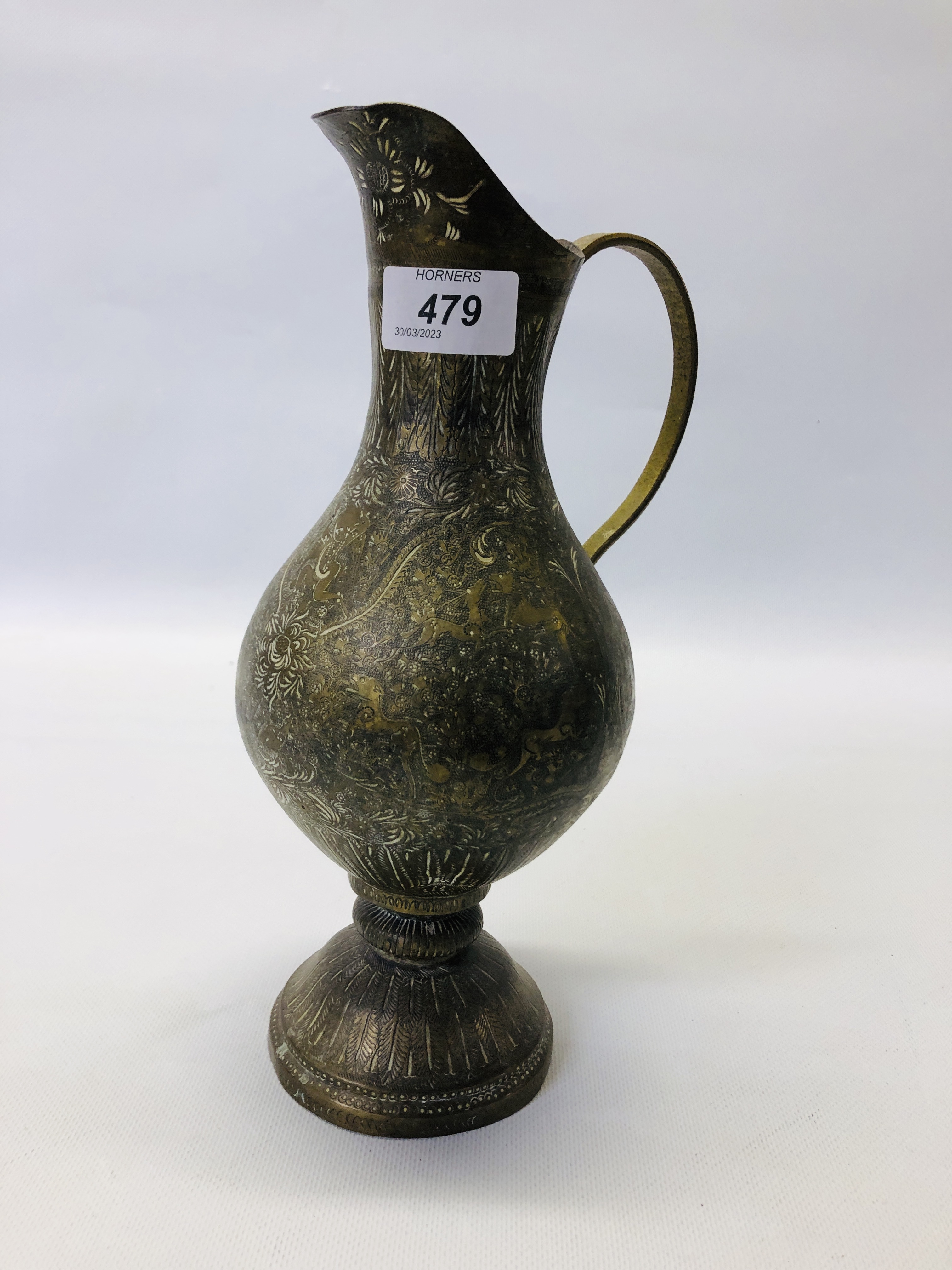 A VINTAGE MIDDLE EASTERN BRASS EWER ALONG WITH AN ELABORATE MIDDLE EASTERN BRASS COFFEE POT. - Image 11 of 21