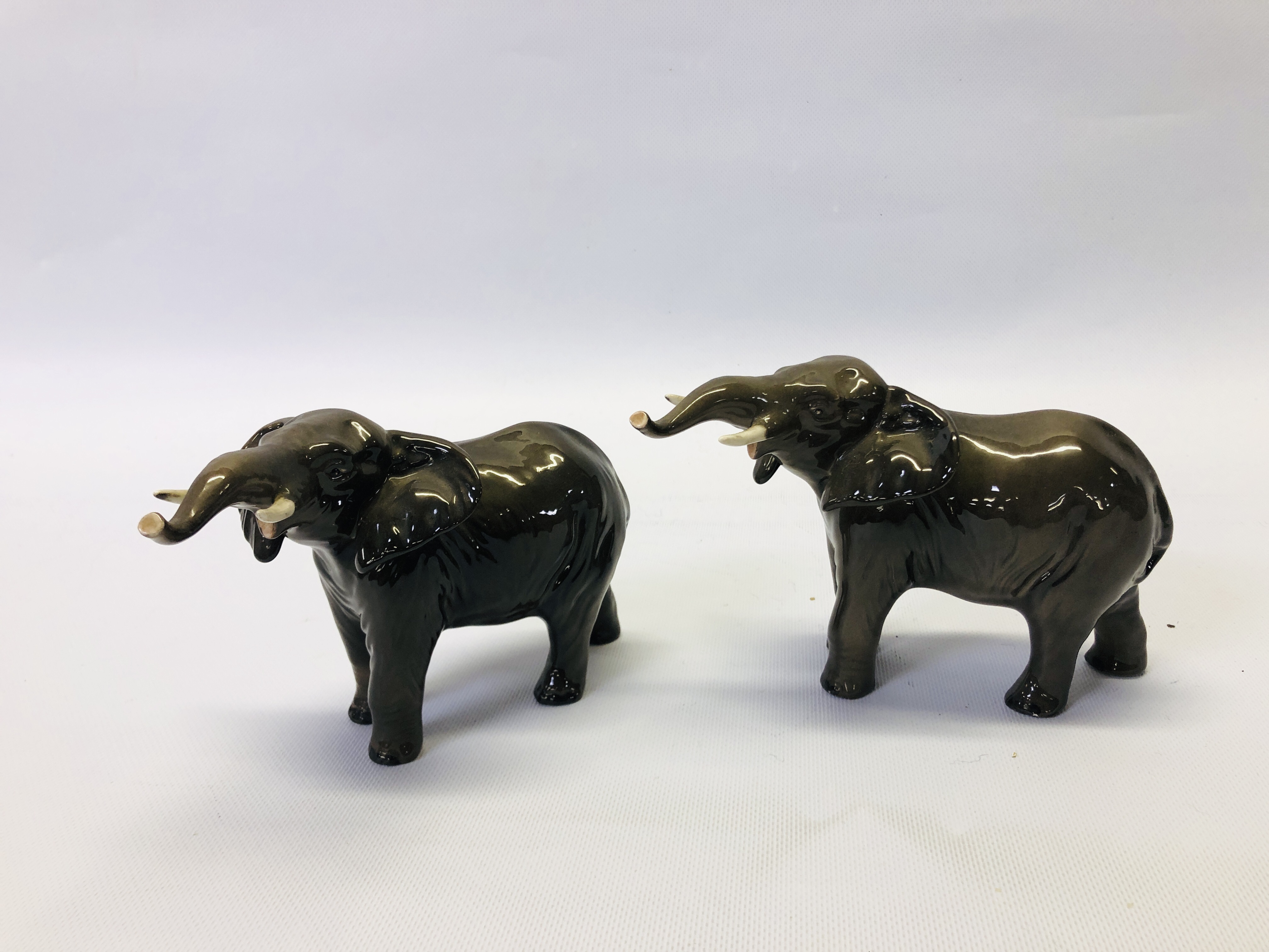 A PAIR OF BESWICK ELEPHANT ORNAMENTS - HEIGHT 12CM.