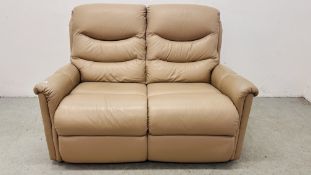 A MODERN CREAM LEATHER TWO SEATER SOFA.