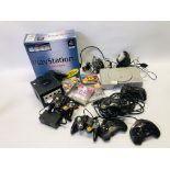 A SONY PLAYSTATION COMPLETE WITH TWO CONTROLS, 4 GAMES TO INCLUDE GRAN TURISMO, PAC-MAN WORLD,