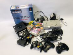 A SONY PLAYSTATION COMPLETE WITH TWO CONTROLS, 4 GAMES TO INCLUDE GRAN TURISMO, PAC-MAN WORLD,