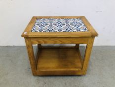 AN OAK TWO TIER TROLLEY THE TOP INSET WITH CERAMIC TILES, DRAWER TO END LENGTH 74CM. WIDTH 54CM.