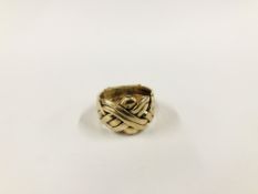 A 9CT GOLD PUZZLE RING.