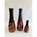A PAIR OF LARGE DESIGNER CARVED WOODEN VASES - HEIGHT 76CM AND ONE SMALLER OF MATCHING DESIGN.