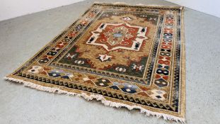 A MODERN MACHINE MADE RUG, THE CENTRAL MOTIF ON A BROWN FIELD 170CM X 230CM.