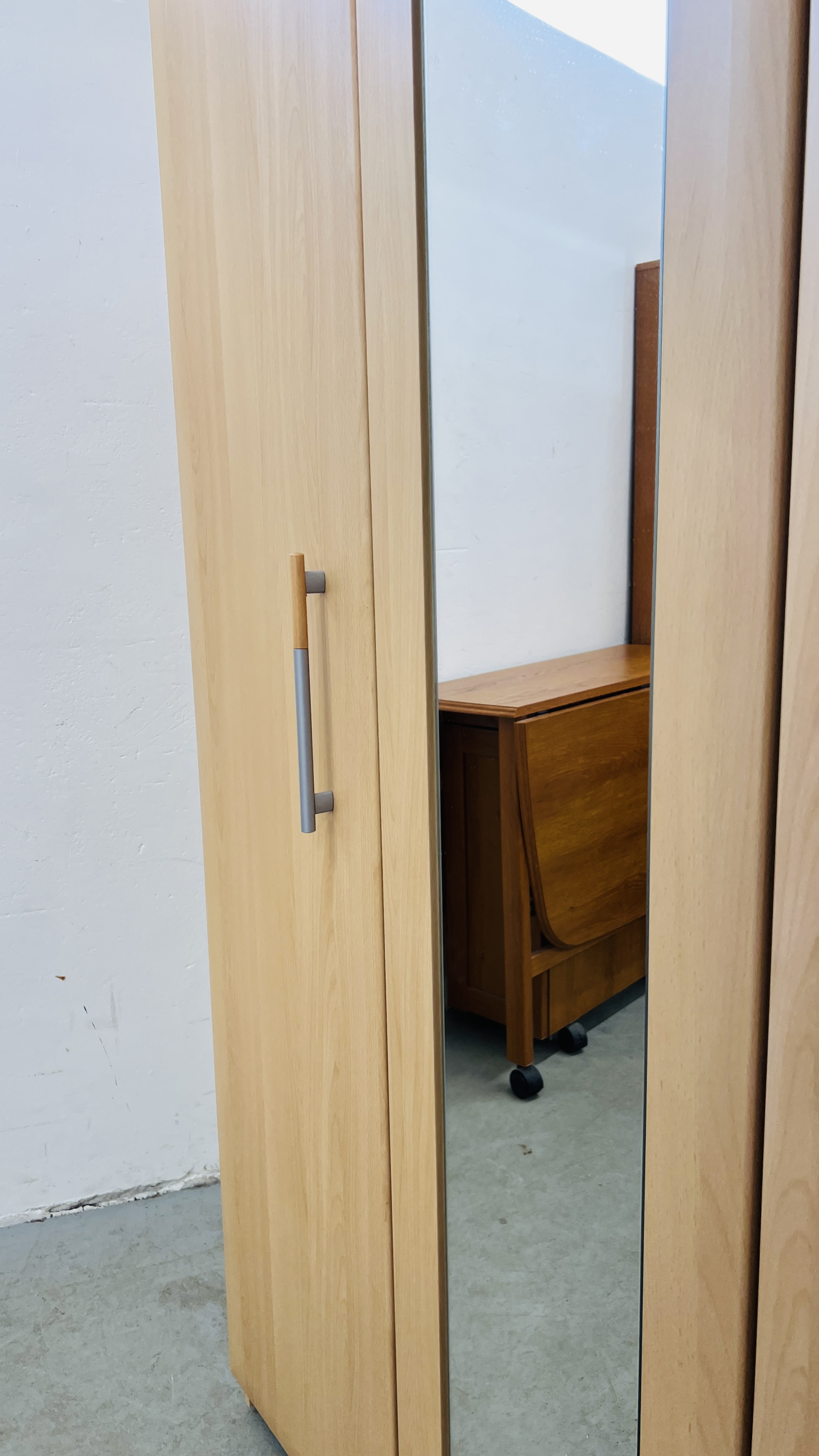 A MODERN BEECH WOOD FINISH TRIPLE WARDROBE WITH CENTRAL MIRRORED DOOR - W 115CM. D 52CM. H 185CM. - Image 3 of 10