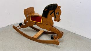 A VINTAGE WOODEN ROCKING HORSE.