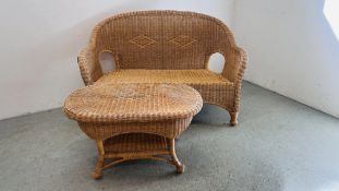 A WICKER CONSERVATORY SOFA AND MATCHING COFFEE TABLE.
