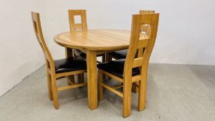 A SOLID OAK CIRCULAR EXTENDING DINING TABLE COMPLETE WITH A SET OF 4 MATCHING SOLID OAK CHAIRS WITH