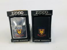 TWO CASED OXFORD UNIVERSITY ZIPPO LIGHTERS.