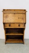 A NARROW OAK FALLING FRONT BUREAU WITH SHELVES BELOW - W 71CM X D 27CM X H 110CM.