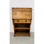 A NARROW OAK FALLING FRONT BUREAU WITH SHELVES BELOW - W 71CM X D 27CM X H 110CM.