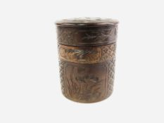 A HAND CARVED CYLINDRICAL DIVISIONAL CONTAINER DECORATED WITH BIRDS AND FOLIAGE - HEIGHT 14CM,