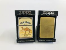 TWO CASED ZIPPO LIGHTERS TO INCLUDE CAMEL CIGARETTES AND SOLID BRASS.