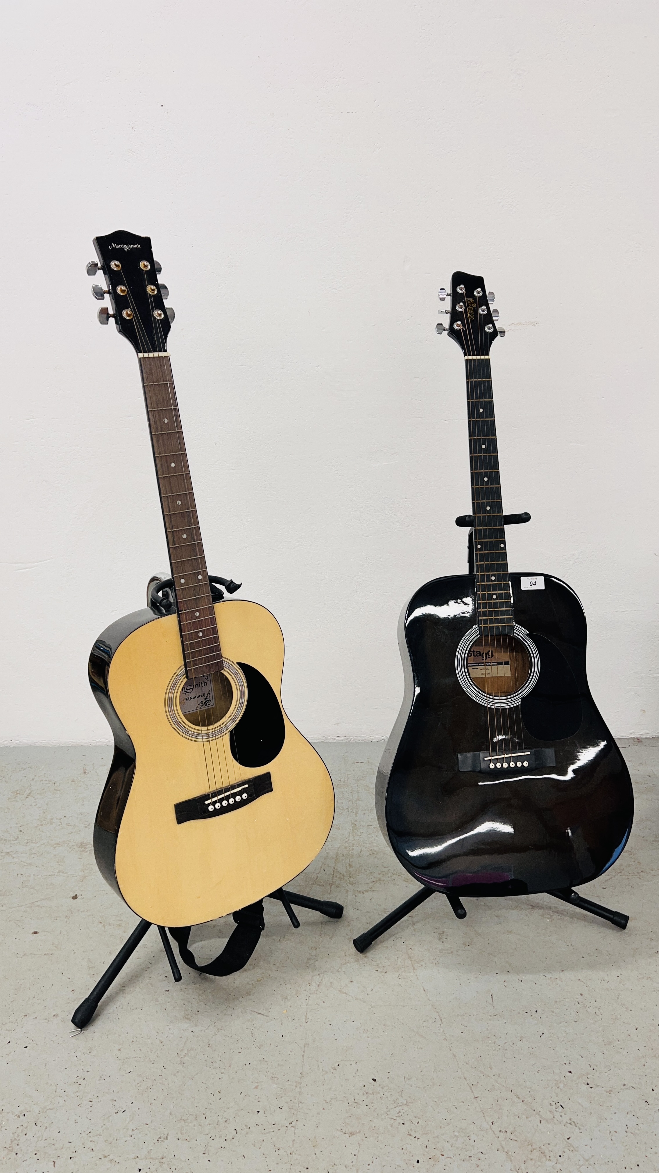 2 ACOUSTIC GUITARS ON STANDS TO INCLUDE STAGG & MARTIN SMITH.