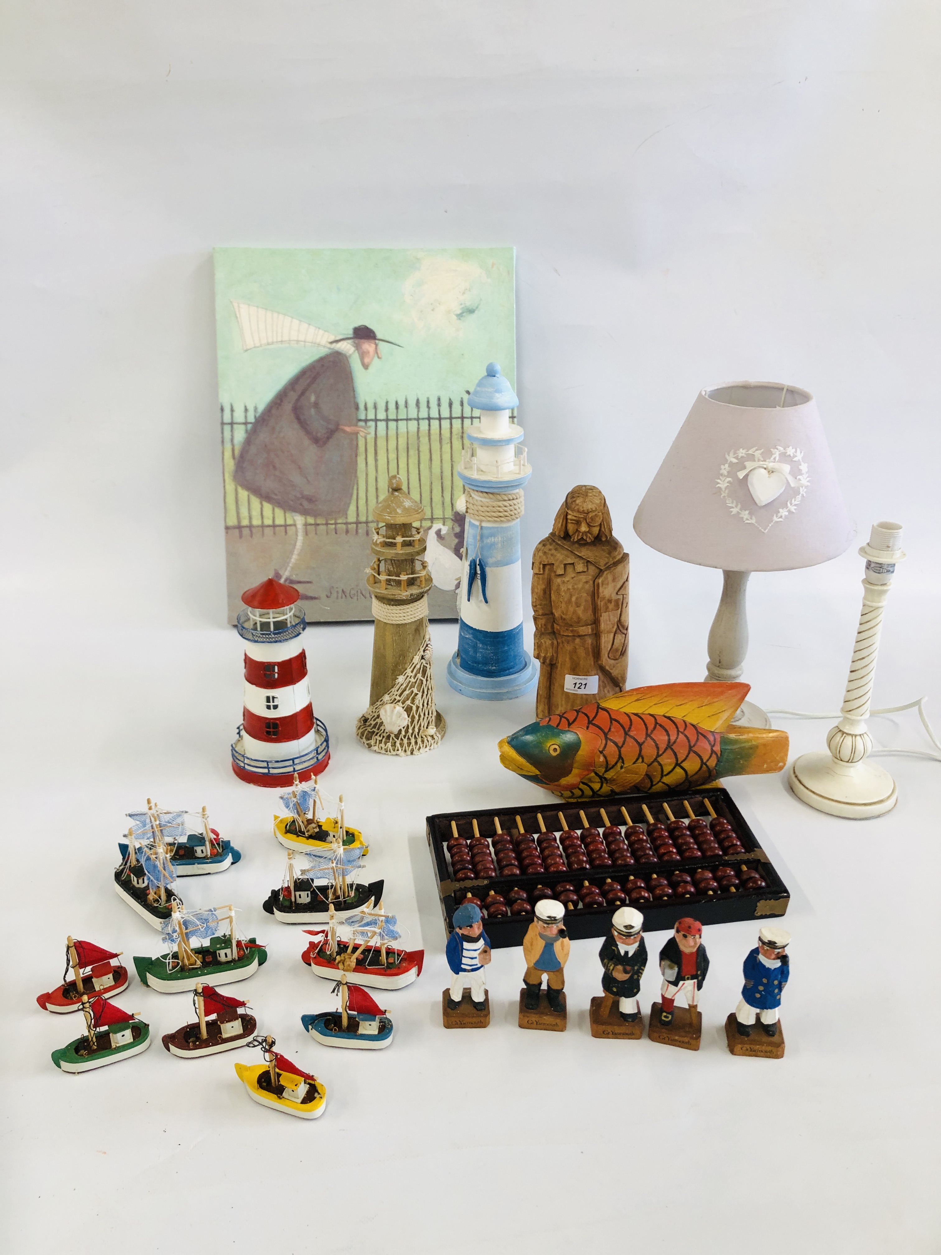 A GROUP OF DECORATIVE EFFECTS TO INCLUDE WOODEN LIGHTHOUSE, WOODEN FISH, WOODEN FISHERMAN FIGURES,