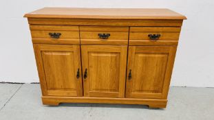 A MODERN CHERRYWOOD FINISH THREE DRAWER CABINET - W 117CM. D 41CM. H 88CM.