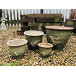 A SET OF FOUR GRADUATED GREEN GLAZED BAMBOO DESIGNED PLANTERS.