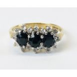 A 9CT GOLD WHITE AND BLUE STONE SET DRESS RING.