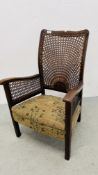 A 1920'S LOW SEAT EASY CHAIR WITH BERGERE WORK TO BACK AND ARMS.