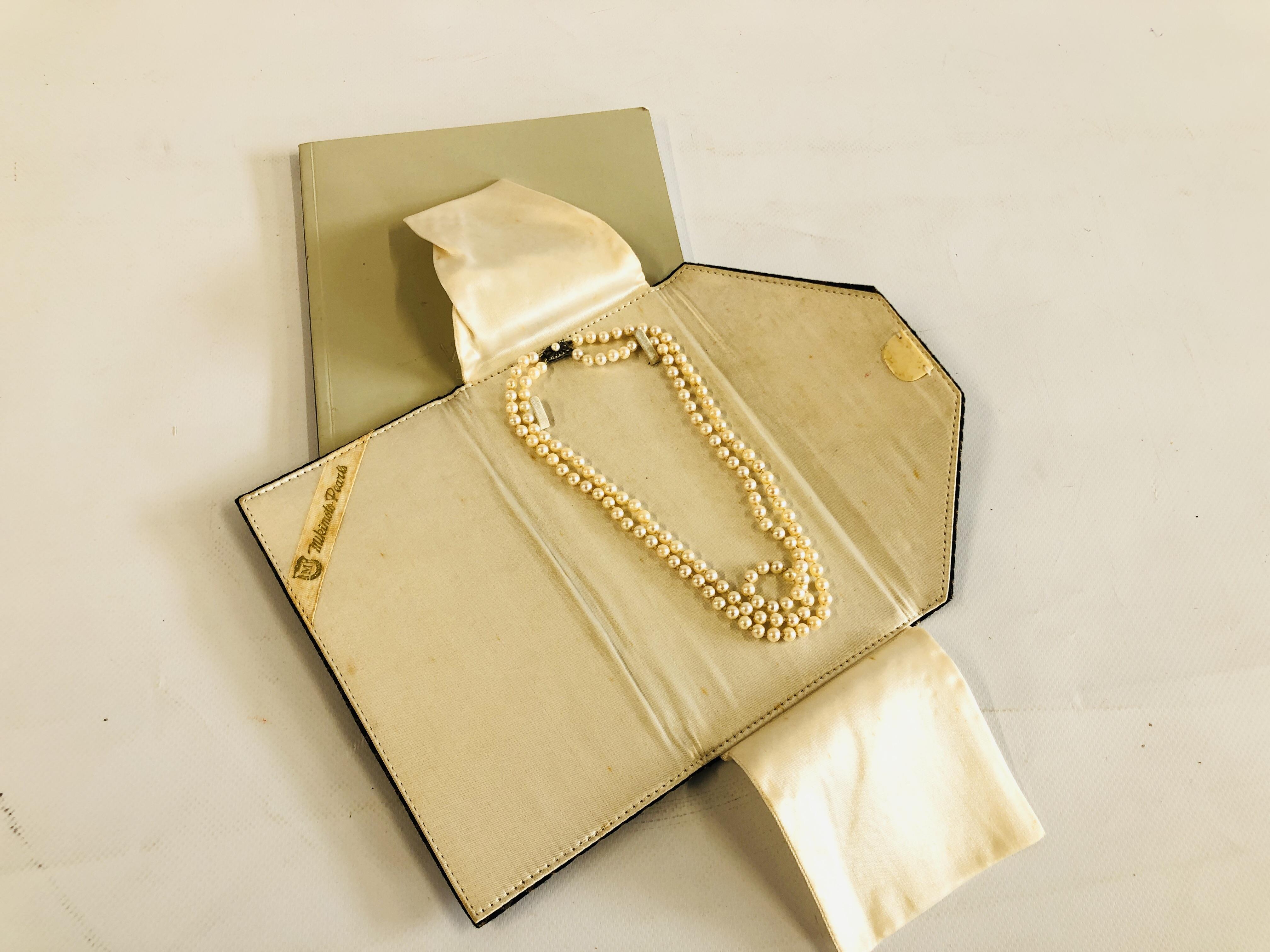 A VINTAGE DOUBLE ROW PEARL NECKLACE BY "MIKIMOTO" ALONG WITH AN ORIGINAL VINTAGE MIKIMOTO SILK