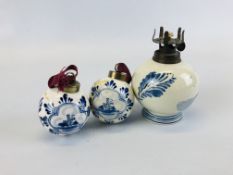 TWO HAND PAINTED DELFT BAUBLES ALONG WITH AN OIL LAMP (NO FONT).