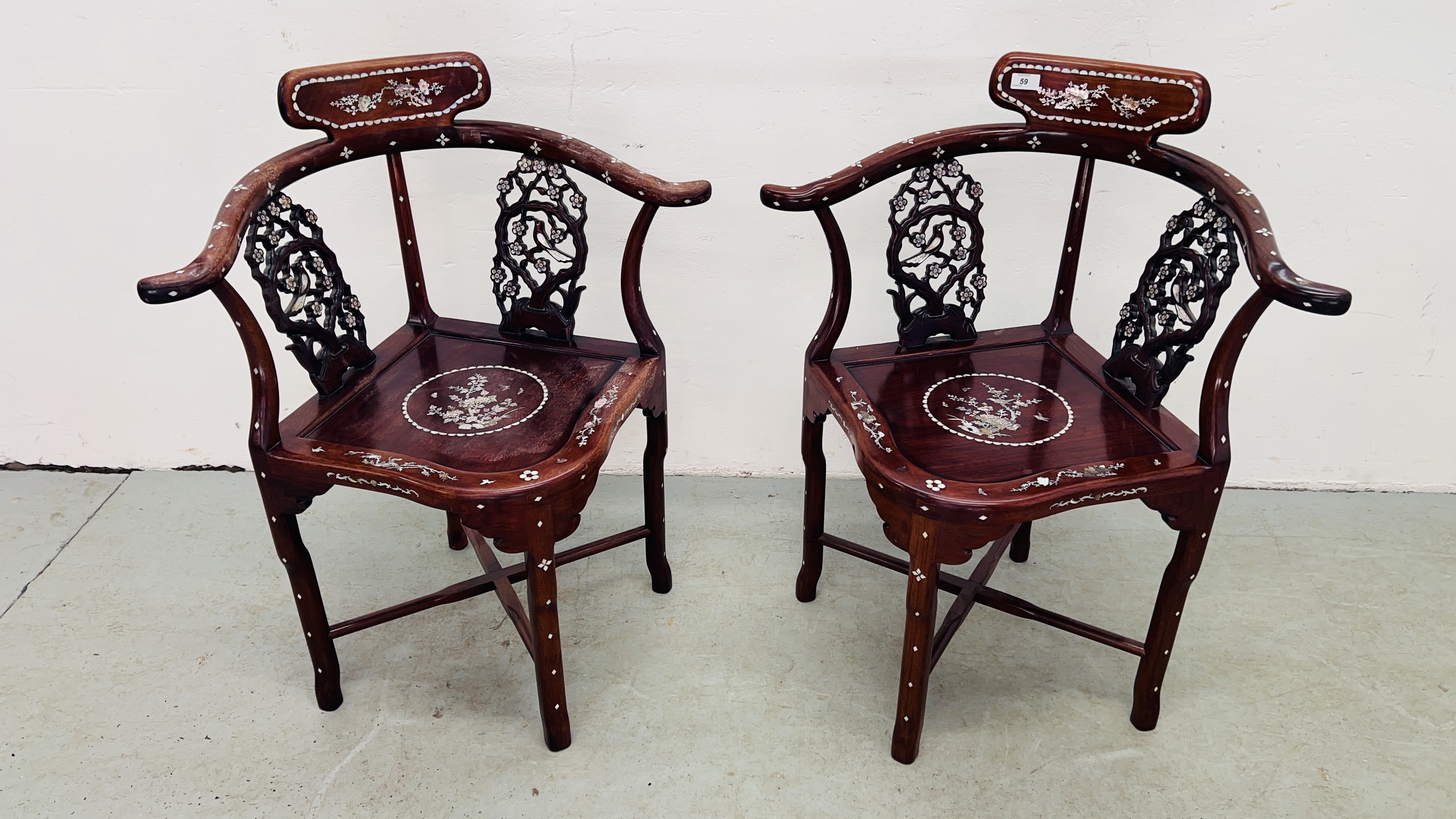 A PAIR OF ORIENTAL HARDWOOD AND MOTHER OF PEARL INLAID CORNER CHAIRS.